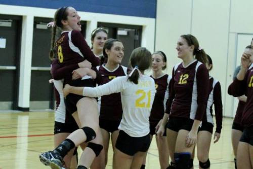 Senior Delaney McCreary is lifted by her teammates after East volleyball defeated Slinger to win the conference championship.  McCreary is one of nine seniors leaving the team.